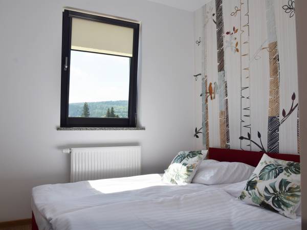 Sypialnia w apartamencie Szum Lasu 