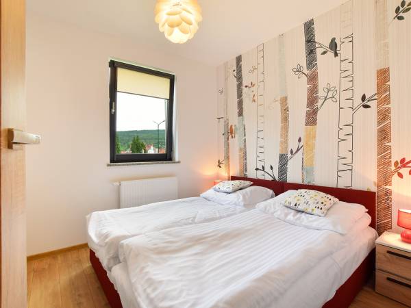Sypialnia w apartamencie Szum Lasu 